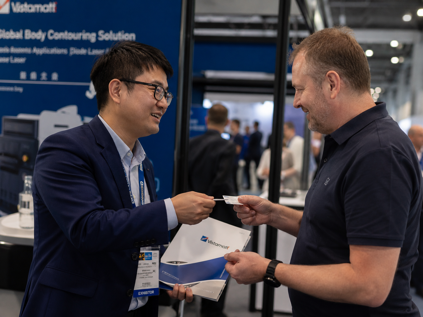 Exchanging business cards with visitor at ECS booth